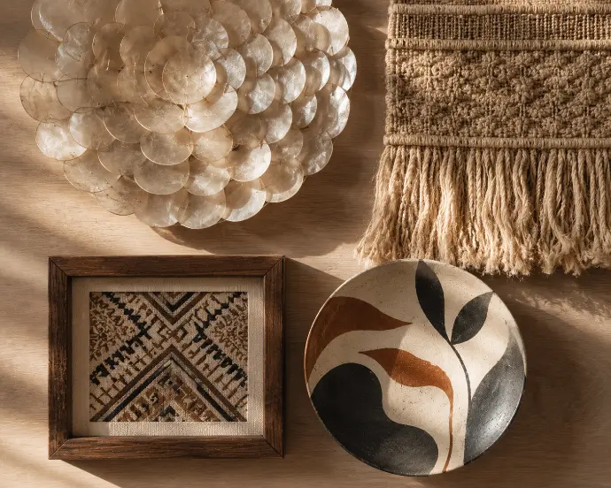 Handmade Filipino wall art including a capiz shell hanging, woven abaca piece, framed indigenous textile, and hand-painted ceramic plate.